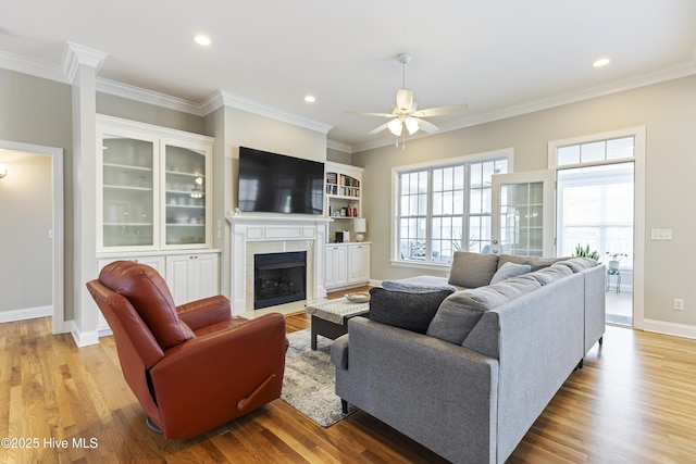 2016 Ashbrook Ct, Leland, NC 28451 - living area featuring a ceiling fan, ornamental molding, a fireplace, light wood-style floors, and recessed lighting