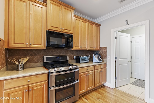 2016 Ashbrook Ct, Leland, NC 28451 - kitchen with black microwave, double oven range, light countertops, ornamental molding, and decorative backsplash