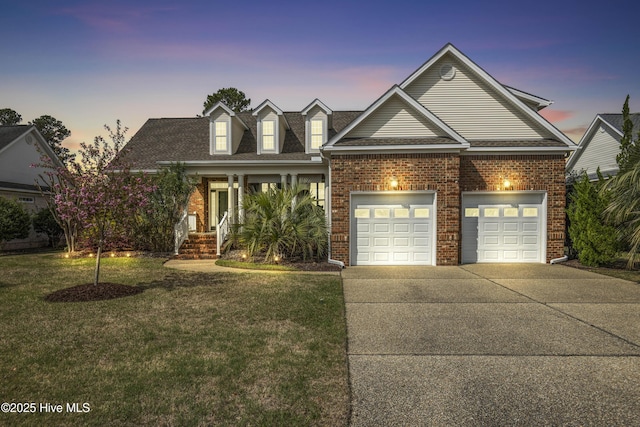 2016 Ashbrook Ct, Leland, NC 28451 - traditional home featuring driveway, brick siding, a front yard, a garage, and roof with shingles