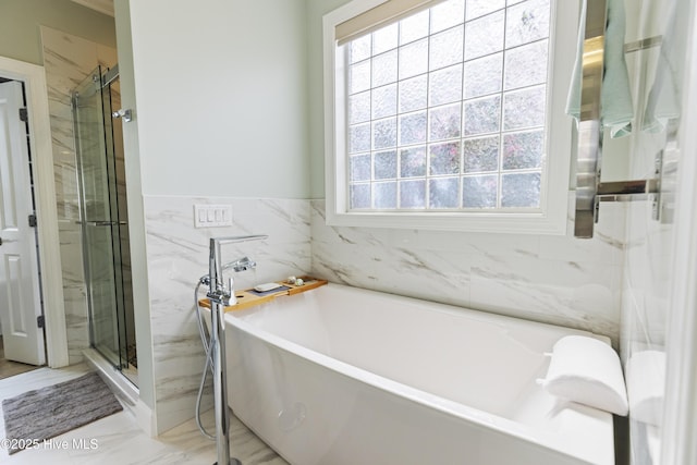2016 Ashbrook Ct, Leland, NC 28451 - bathroom with a stall shower, a freestanding tub, tile walls, and marble finish floors