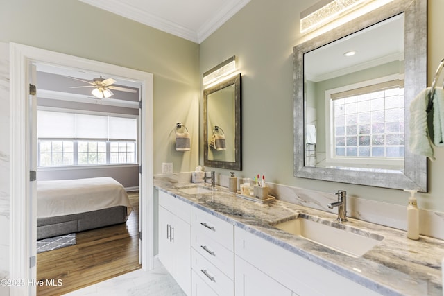 2016 Ashbrook Ct, Leland, NC 28451 - ensuite bathroom featuring ornamental molding, double vanity, marble finish flooring, a ceiling fan, and baseboards