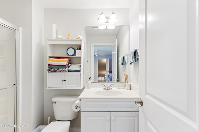 2016 Ashbrook Ct, Leland, NC 28451 - bathroom featuring vanity, a ceiling fan, a shower with shower door, and toilet