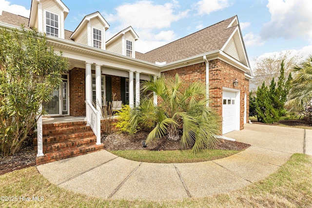 2016 Ashbrook Ct, Leland, NC 28451 - view of front of house featuring covered porch, brick siding, a shingled roof, and a garage