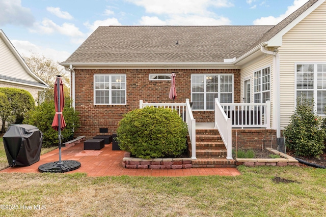 2016 Ashbrook Ct, Leland, NC 28451 - rear view of house with a yard, a patio, roof with shingles, brick siding, and crawl space