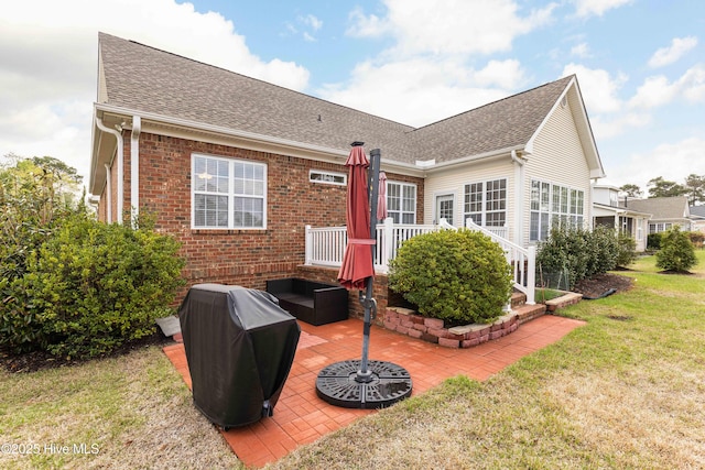 2016 Ashbrook Ct, Leland, NC 28451 - back of property with a yard, a shingled roof, brick siding, and a patio