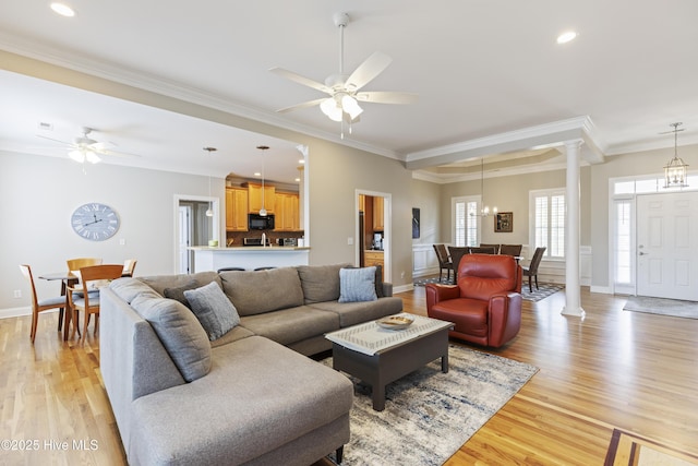 2016 Ashbrook Ct, Leland, NC 28451 - living room featuring decorative columns, a ceiling fan, light wood finished floors, crown molding, and recessed lighting