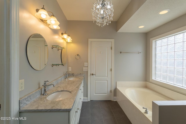 bathroom featuring tile patterned flooring, a bath, double vanity, baseboards, and a chandelier