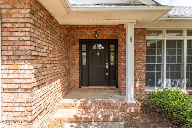 property entrance with brick siding