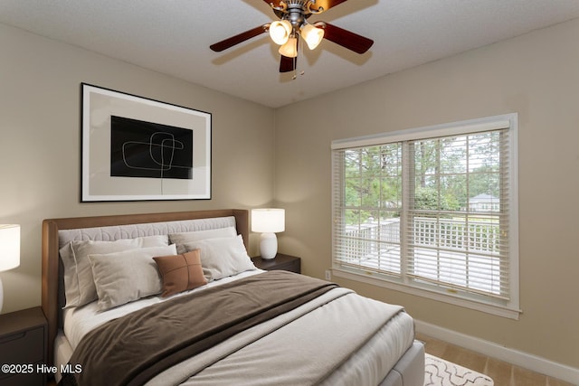 bedroom featuring baseboards and a ceiling fan