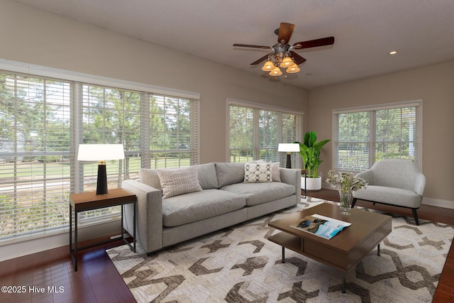 living room with ceiling fan, wood finished floors, recessed lighting, and baseboards