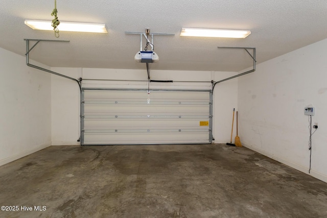 garage featuring a garage door opener and baseboards