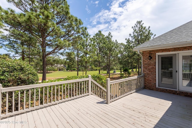 wooden terrace featuring view of scattered trees