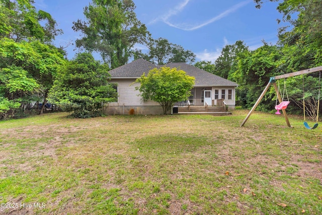 707 Brown Pelican Ln, Hampstead, NC 28443 - view of green lawn with a deck and a playground