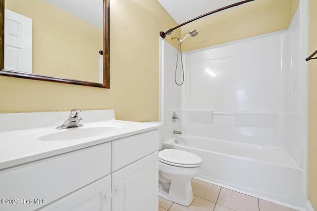 bathroom featuring tile patterned floors, toilet, vanity, and shower / tub combination