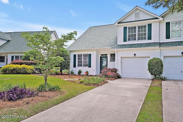 view of front of home with concrete driveway, a front lawn, a garage, and roof with shingles