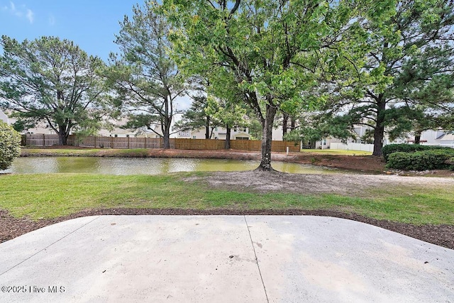 view of yard with a patio area and a water view