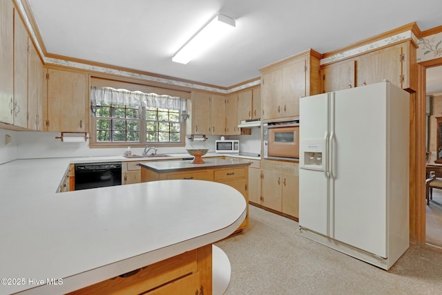 kitchen featuring white appliances, a sink, light countertops, under cabinet range hood, and a peninsula