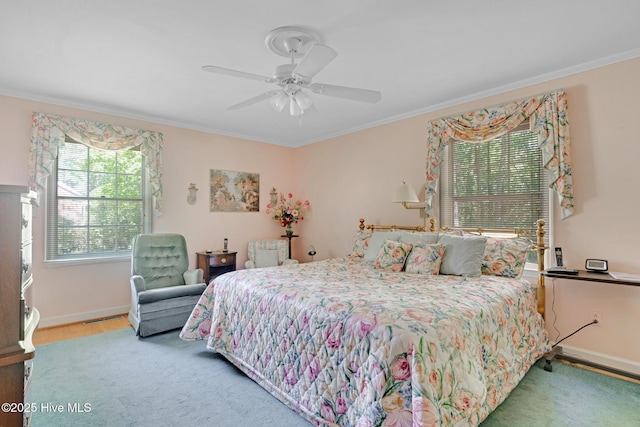 bedroom with crown molding, baseboards, wood finished floors, and a ceiling fan