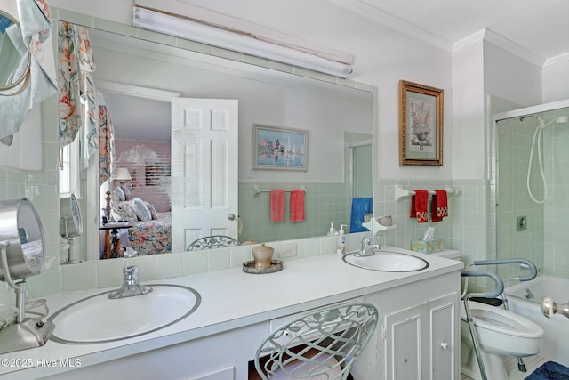 ensuite bathroom featuring crown molding, double vanity, toilet, enclosed tub / shower combo, and tile walls