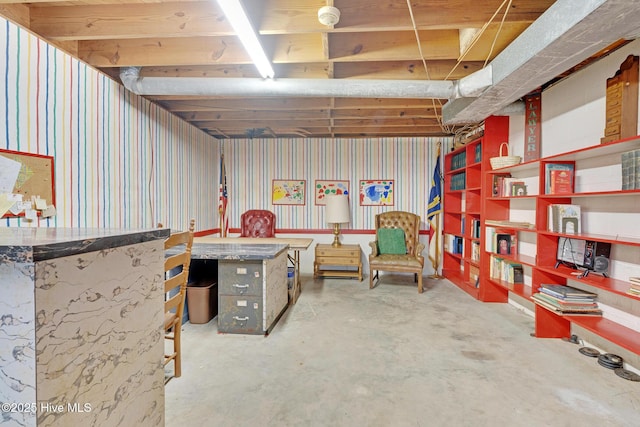 below grade area featuring wallpapered walls