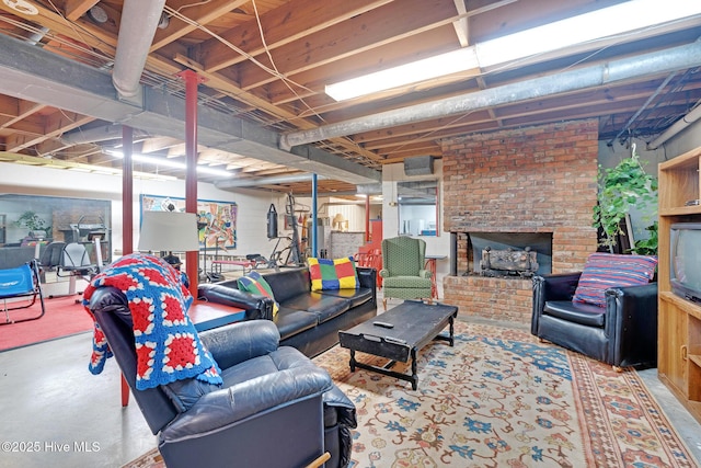 living room featuring concrete flooring and a brick fireplace