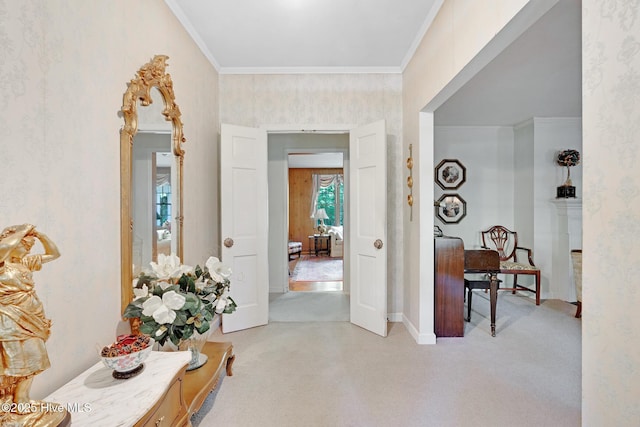 hallway featuring light carpet, ornamental molding, baseboards, and wallpapered walls