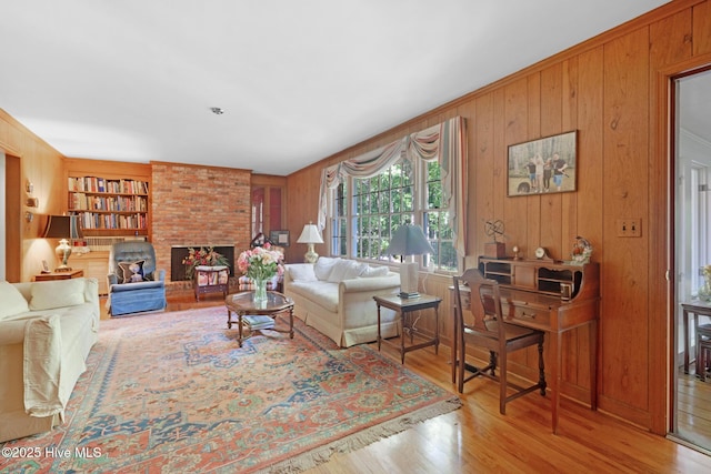 living area with wood walls, wood finished floors, and built in shelves