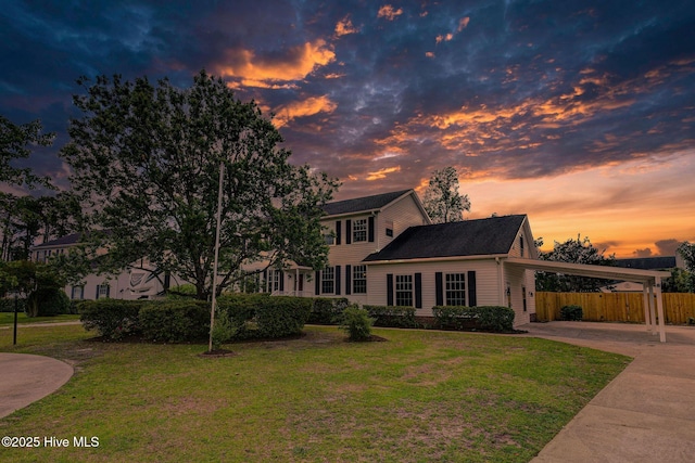 colonial home with driveway and a carport