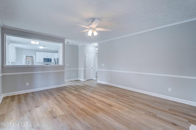 unfurnished living room featuring a textured ceiling, a ceiling fan, light wood-type flooring, crown molding, and baseboards