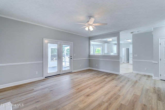 unfurnished living room with crown molding, ceiling fan, light wood-style flooring, a textured ceiling, and baseboards