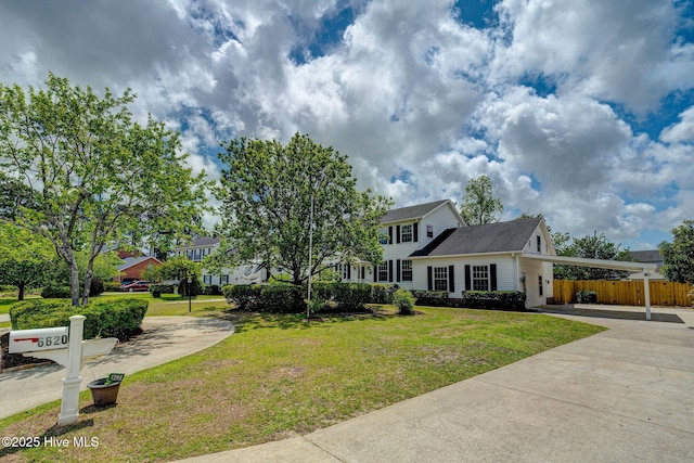 colonial home featuring driveway and a carport