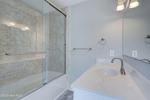 full bathroom with enclosed tub / shower combo and vanity