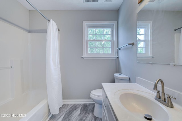 full bath featuring toilet, vanity, shower / bathtub combination with curtain, and baseboards