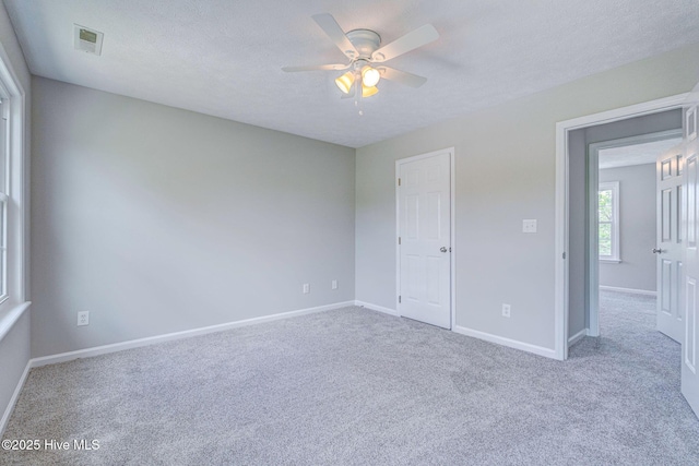 unfurnished bedroom featuring carpet, baseboards, and a ceiling fan