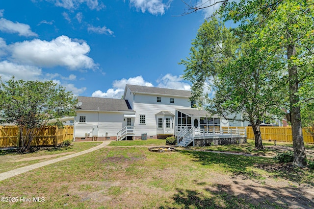 back of house featuring a sunroom, crawl space, and roof with shingles