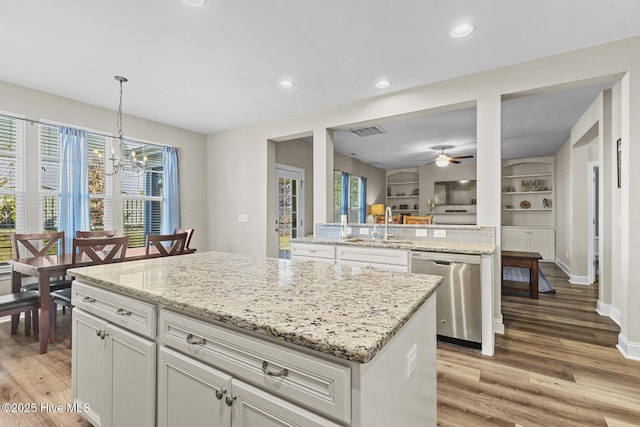 211 Willow Ridge Dr, Holly Ridge, NC 28445 - kitchen with dishwasher, a sink, a center island, light wood-style flooring, and a chandelier