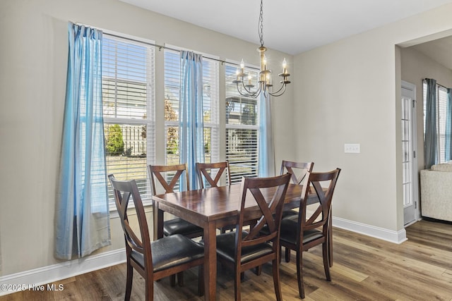 211 Willow Ridge Dr, Holly Ridge, NC 28445 - dining space with baseboards, a chandelier, and wood finished floors