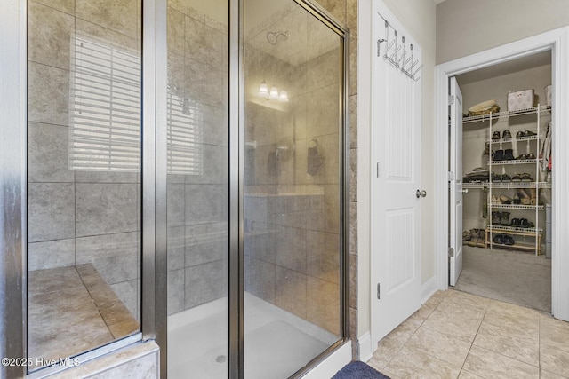 211 Willow Ridge Dr, Holly Ridge, NC 28445 - bathroom featuring a stall shower, tile patterned floors, and a walk in closet