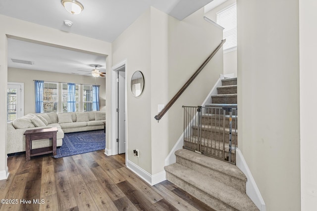 211 Willow Ridge Dr, Holly Ridge, NC 28445 - staircase featuring wood finished floors, ceiling fan, and baseboards