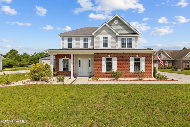 134 Inverness Dr, Hubert, NC 28539 - view of front of house featuring brick siding, a front lawn, and covered porch