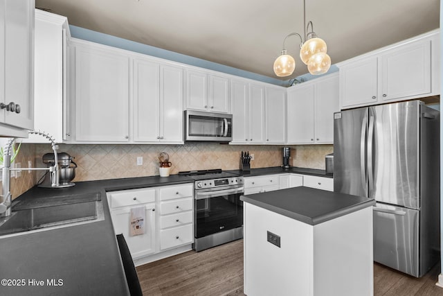 134 Inverness Dr, Hubert, NC 28539 - kitchen with appliances with stainless steel finishes, dark countertops, dark wood finished floors, and white cabinetry