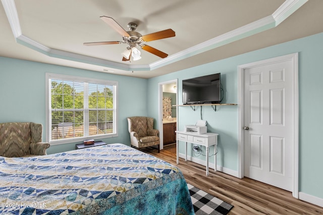 134 Inverness Dr, Hubert, NC 28539 - bedroom featuring a tray ceiling, crown molding, wood finished floors, baseboards, and a ceiling fan