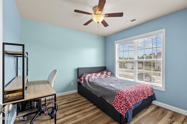 134 Inverness Dr, Hubert, NC 28539 - bedroom featuring baseboards, wood finished floors, a ceiling fan, and an office area
