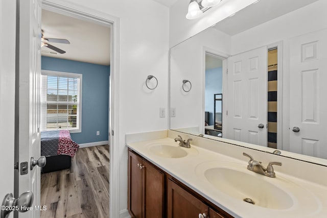 134 Inverness Dr, Hubert, NC 28539 - ensuite bathroom featuring wood finished floors, a ceiling fan, double vanity, and baseboards