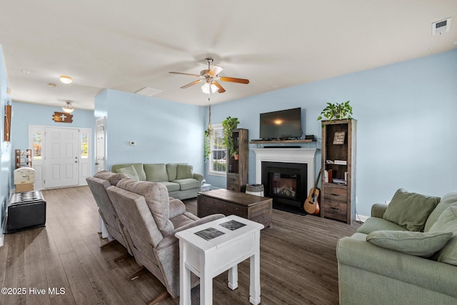 134 Inverness Dr, Hubert, NC 28539 - living room featuring dark wood finished floors, ceiling fan, and a glass covered fireplace