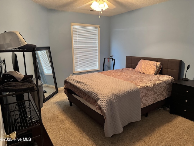 bedroom featuring light carpet and a textured ceiling
