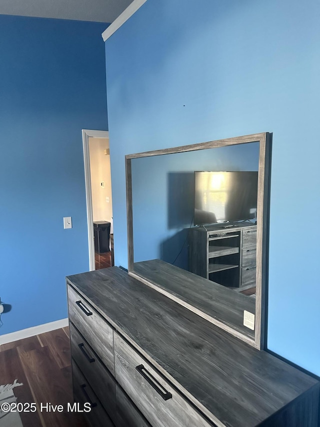 bedroom featuring dark wood-style flooring and baseboards