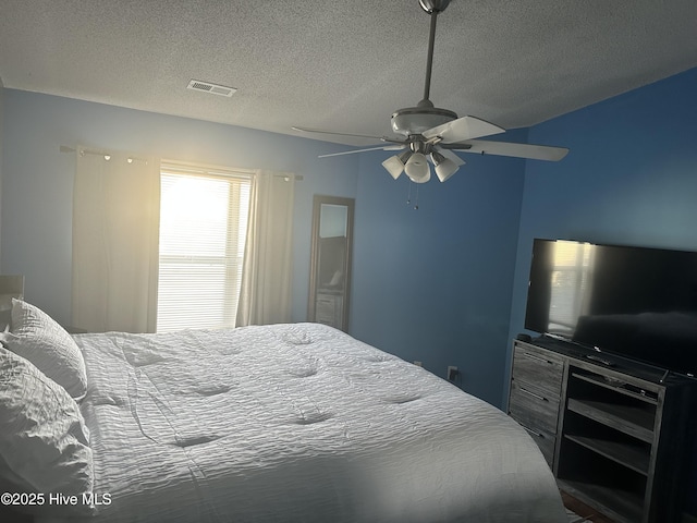 bedroom featuring a textured ceiling and a ceiling fan