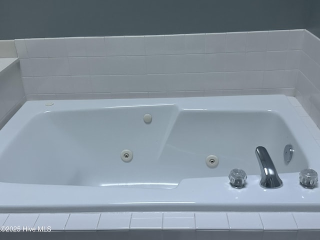 bathroom view of a tub with jets