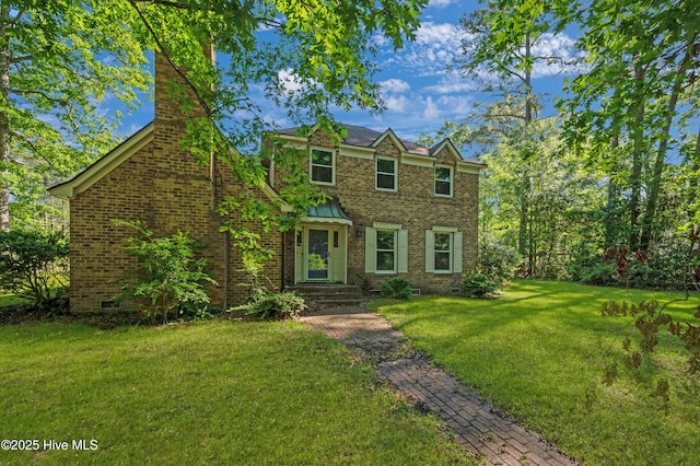 view of front of home with crawl space, brick siding, and a front yard